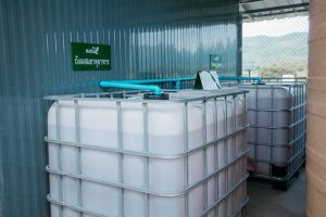 a group of white containers with blue pipes